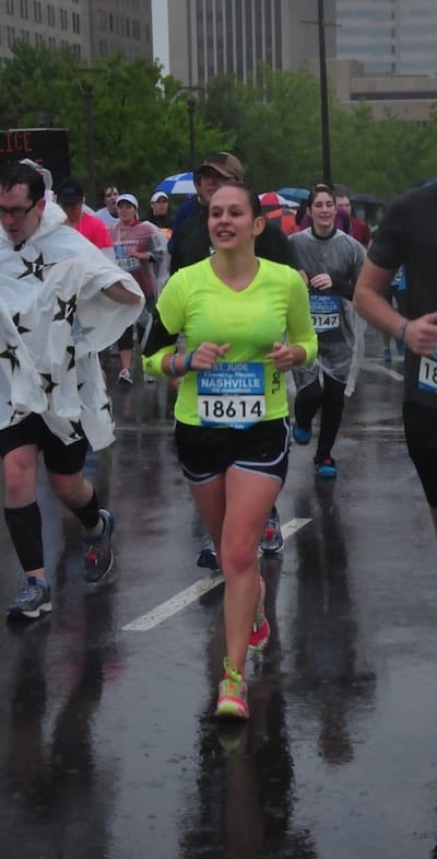Runner runs half marathon during heavy rainstorm. With a marathon packing list a runner will be well-prepared for many types of weather on race day.