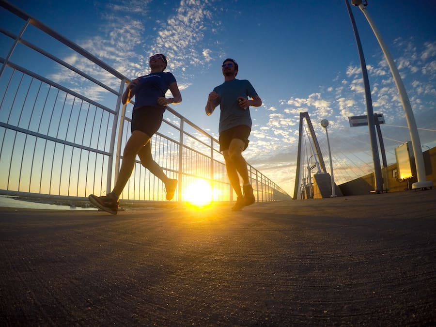 Two runners cross over the Arthur Ravenel Jr. Bridge in Charleston, South Carolina, USA.