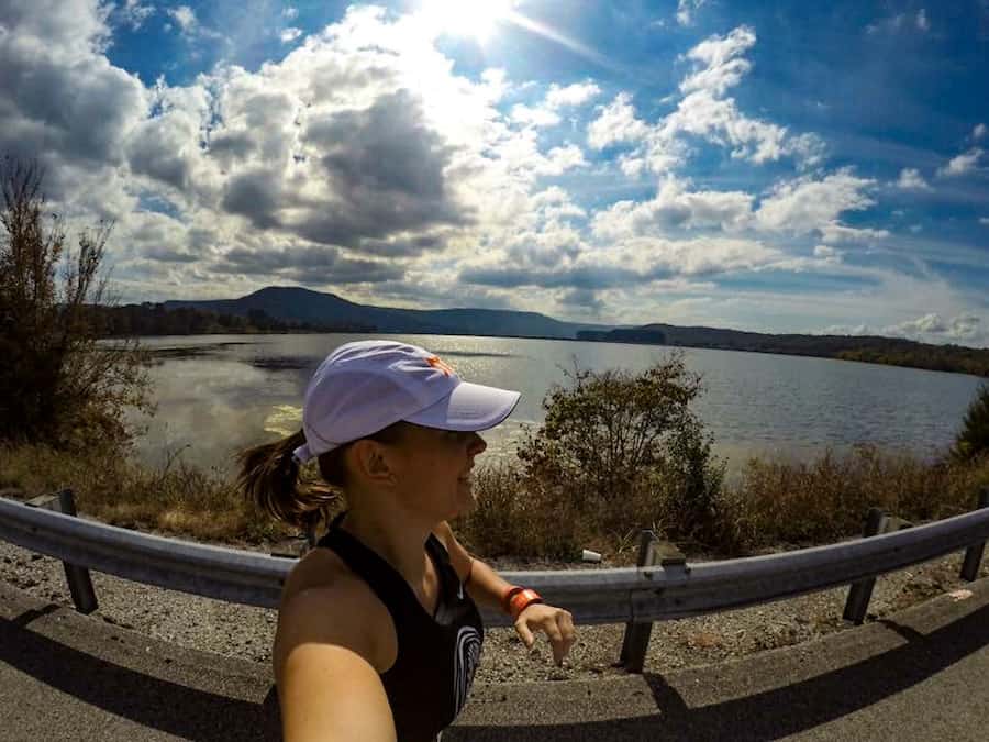 Runner runs on roadside along a lake in Tennessee.