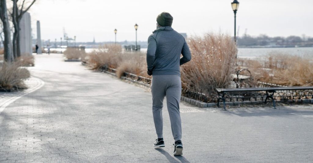 A person is running on what looks to be a frigid day. Sometimes you may need to complete your 20-mile run in freezing temps. Remember to layer!