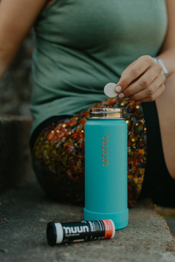 I'm placing a Nuun Hydration tablet into my Nuun bottle before my run. Nuun is a great low calorie beverage option with only 15 calories per serving.